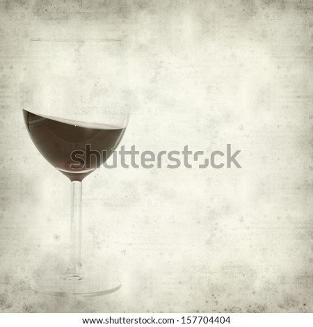 textured old paper background with swirled red wine