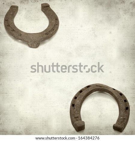 textured old paper background with rusty horseshoe