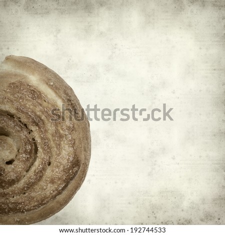textured old paper background with scandinavian cinnamon bun