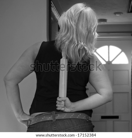 waiting for beloved (candid settings shot of woman waiting by the front door with rolling pin behind her back)