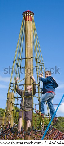 two brothers on playground, climbing a roped frame