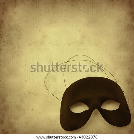 textured old paper background with carnival half mask