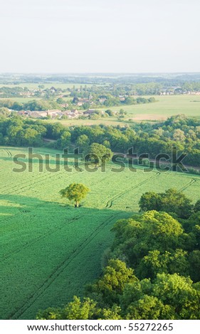 view over the early summer green fields and a small village from the air; East Anglia; UK