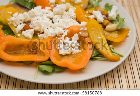 summer light meal -- fried sweet pepper with  garlic and crumbled feta cheese, on a bed of rocked salad
