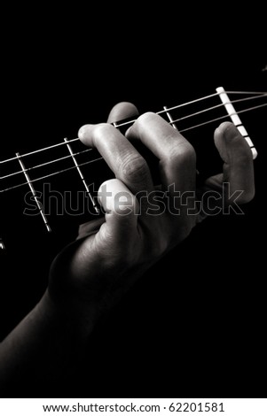 Major  chord (G) on classical guitar; toned monochrome image;