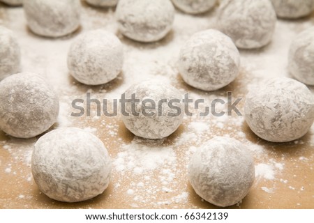 tray of  chocolate dough balls with icing sugar dusting (making cookies) abouit to go into oven