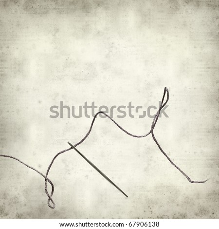 textured old paper background with sewing needle and tread
