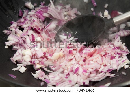 frying onion in black cast iron pan