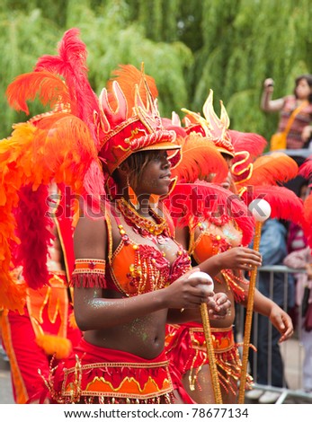 LUTON, UK - MAY 30: Unidentified majorettes take part in carnival parade under heavy rain at annual Luton Carnival on May 30, 2011 in Luton, UK