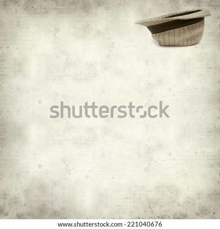 textured old paper background with old broken panama straw hat