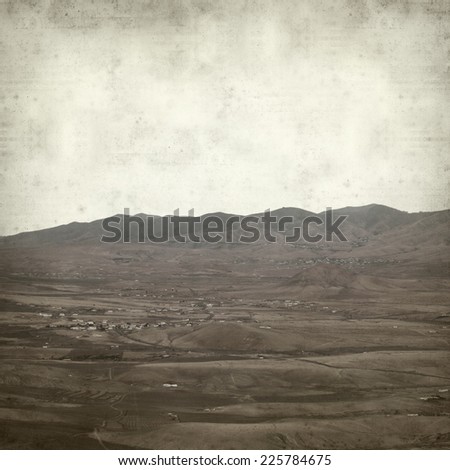 textured old paper background with mountains of Fuerteventura