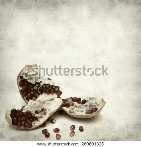 textured old paper background with pomegranate seeds