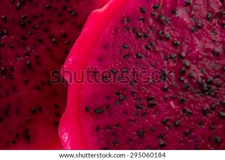 cut red dragon fruit with black seeds food background