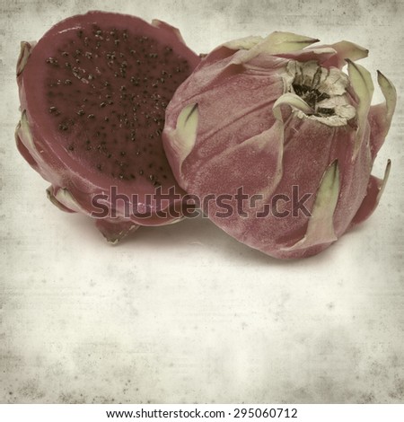 textured old paper background with cut red dragon fruit