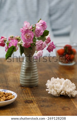 Rose flowers and food on the table.