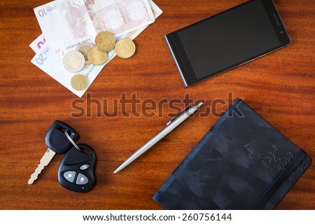 the contents of the pockets of men on a brown wooden table