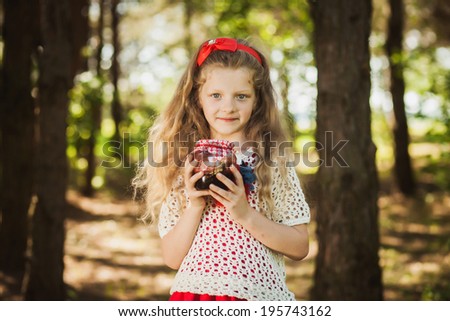 Little girl with a tasty jar of jam