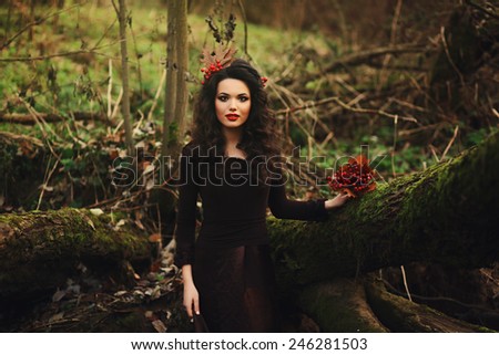 Portrait of romantic young woman in fairy forest
