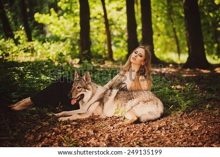 cute girl with a dog resting on the morning forest