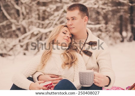 portrait of a sweet couple with a mug of tea in his hands
