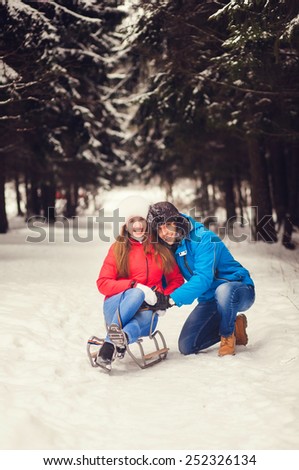 happy couple spend a fun weekend in the winter forest