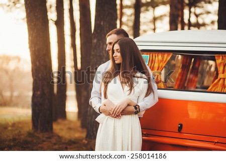 Young couple in love outdoor. Sensual outdoor portrait of young stylish couple in summer in park.