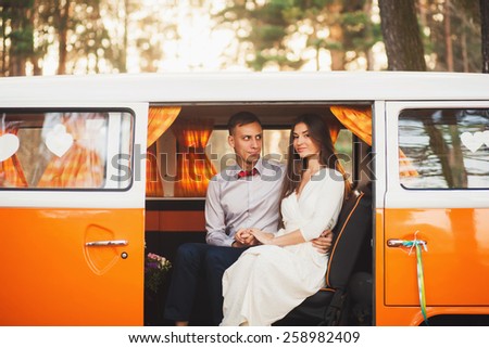 romantic couple sitting in the car at sunset. Summer vacation