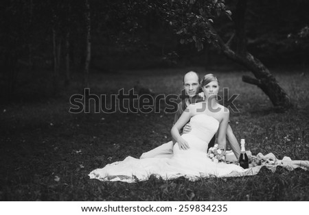 Cute couple sitting on a picnic. Black white  image