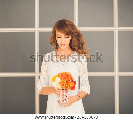 loving bride with a bouquet of flowers. morning before the wedding