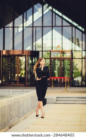 stylish lady pencil skirt posing looking away. full-length