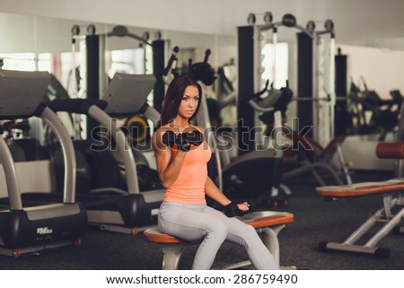 Image of healthy young female athlete doing fitness workout in fitness center. copy space