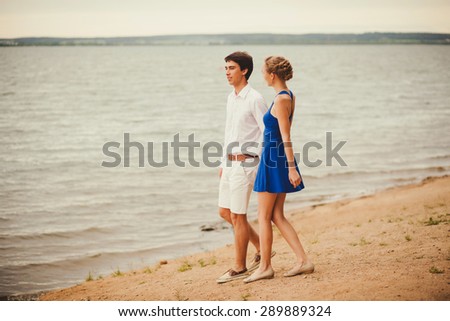 happy couple enjoying a walk together. Honeymoon at the lake
