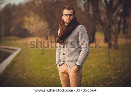 young attractive man in cardigan and glasses