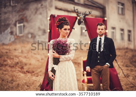 glamorous couple standing near the decor. focus on woman