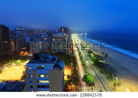 Night view of Ipanema beach after sunset, hotels, buildings, sea with fog from the sea on the background, Rio de Janeiro, Brazil