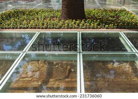 Floor laminated glass with vision of archaeological sidewalks on Tiradentes square, city center of Curitiba, Parana state, Brazil