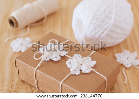 White crochet snowflakes for Christmas decoration of box gift. Selective focus
