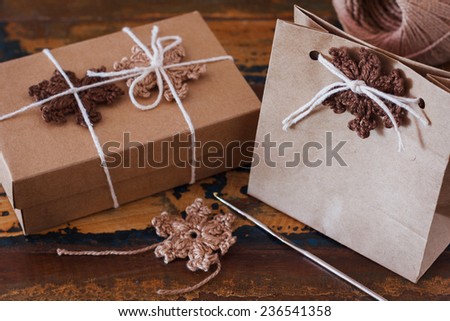 Brown crochet snowflakes for Christmas decoration of package and gift box. Selective focus