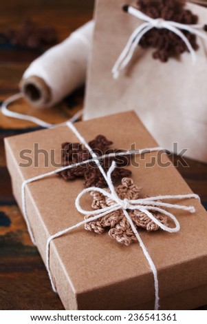 Brown crochet snowflakes for Christmas decoration of gift box and package. Selective focus