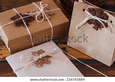 Brown crochet snowflakes for Christmas decoration of gift box and greetings card. Selective focus