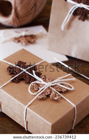 Brown crochet snowflakes for Christmas decoration of gift box, package and handmade greetings card. Selective focus
