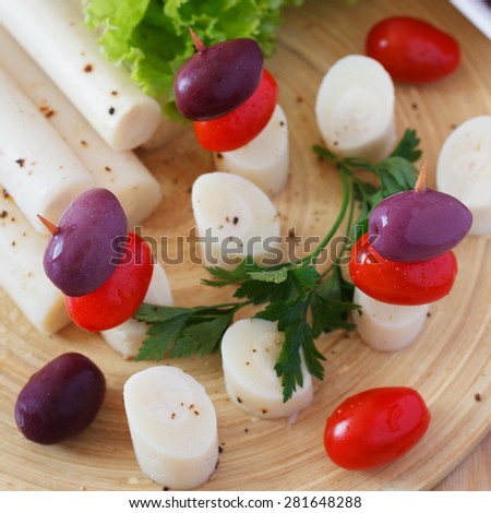 Canape of Heart of palm (palmito), cherry tomatos, olives. Selective focus