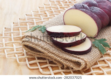 Treccia - braided Mozzarella cheese marinated in red wine on sackcloth. Selective focus