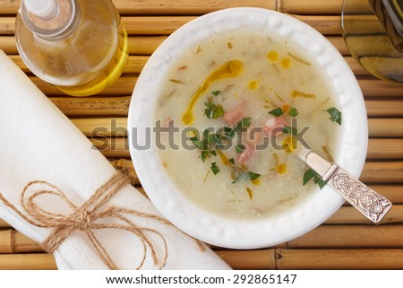 Caldo verde - soup in Portuguese, brazilian cuisine in white plate. Selective focus