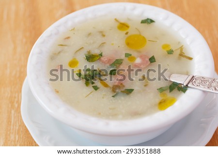 Caldo verde - soup in Portuguese, brazilian cuisine in white plate. Selective focus