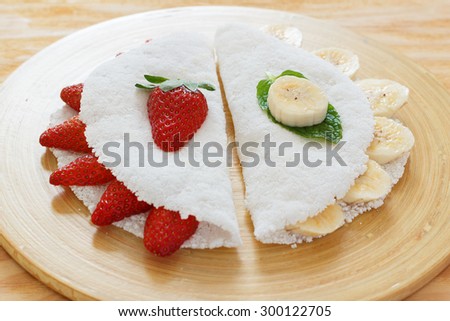 Casabe (bammy, beiju, bob, biju) - flatbread made from cassava (tapioca) with strawberry and banana. Selective focus