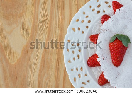 Casabe (bammy, beiju, bob, biju) - flatbread made from cassava (tapioca) with strawberry on white vintage plate. Selective focus. Copy space