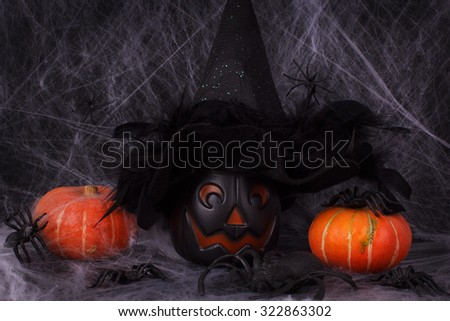 Halloween pumpkins, spider, spider web, witch hat. Selective focus