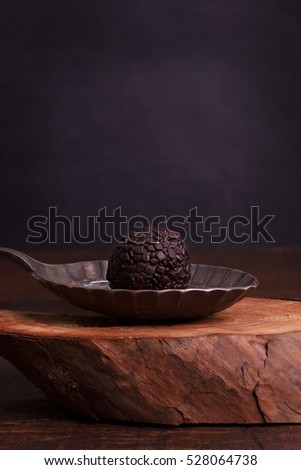 Brazilian chocolate truffle bonbon brigadeiro on wooden table. Selective focus. Copy space