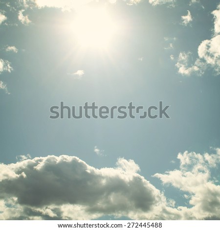 Sun above clouds - toned effect. Springtime sky - vintage photo. Sky with clouds and sun - retro filter.